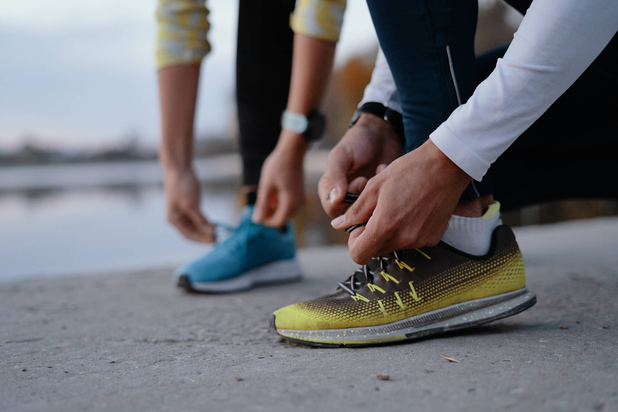 Young Couple Yying Sports Shoes. Young Couple Yying Sports Shoes.